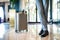 Businessman with suitcase in a hotel entrance hall.