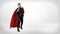A businessman in a superhero red cape and a mask throwing punches in the air on white background in high contrast shot.