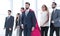 Businessman in Superman cloak and business team standing in office lobby