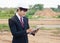 Businessman surveying land for industrial project.Selective focus at hand