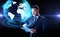 Businessman with tablet pc and earth hologram