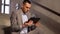 Businessman with tablet pc at office stairs