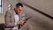 Businessman with tablet pc at office stairs