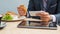 Businessman with tablet and smartphone during breakfast.