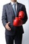 Businessman take off boxing gloves to offer a handshake on white