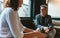 Businessman talking with female colleague in office lobby