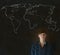 Businessman, teacher or student with world geography map on chalk background