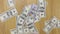 Businessman throws dollars on wooden table, background of money