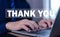 businessman touches the laptop and sends message words to thank you. Letter writing concept. congratulation, appreciation, and
