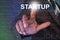 Businessman touching startup button on virtual screen