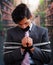 Businessman trapped in a chair with rope, with a black tape in his mouth and hands in a blurred background