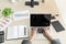 The businessman while typing an information on laptop with office accesssories setting on wood table. /Business and technology con