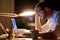 Businessman typing on laptop at night office