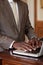 Businessman typing on a laptop at a wooden desk.