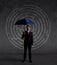 Businessman with umbrella standing over labyrinth background. Business, strategy, insurance, concept.