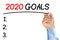 Businessman underlining 2020 goals text with black felt-tip