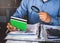 Businessman use Magnifying glass and calculator to find something in account book