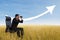 Businessman using binoculars looking at growing chart cloud