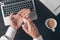 Businessman using disinfectant spray to disinfect hands while working office desk