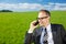 Businessman using his mobile in the countryside