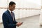 Businessman using mobile phone in warehouse