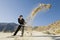 Businessman Using A Shovel In Desert