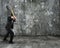 Businessman using sledgehammer cracking wall broken on concrete