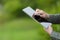 Businessman using a smart tablet on a green summer day.