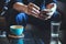 Businessman using smartphone to read investment news and reply email to confirm meeting in coffee shop. man drinking latte coffee