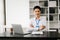 Businessman using tablet and laptop for doing math finance on an office desk, tax, report, accounting, statistics, and analytical