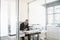 Businessman Using Telephone And Calculator At Desk