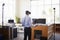 Businessman using VR technology in an office, back view