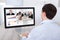 Businessman video conferencing with colleagues on pc at desk