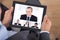 Businessman video conferencing with coworkers on digital tablet