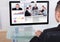 Businessman video conferencing with team