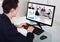 Businessman video conferencing with team in office