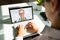 Businessman videoconferencing with doctor on laptop