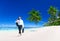 Businessman Walking Along Tropical Beach Concept