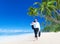 Businessman Walking Along the Tropical Beach Concept