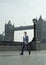 Businessman Walking In Front Of London Bridge