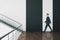 Businessman walking in minimalistic hall interior with stairs