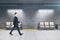Businessman walking in modern underground railway station
