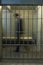 Businessman Walking In Prison Cell