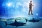 The businessman walking on stilts among sharks