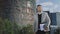 Businessman walking on street. Confident executive holding documents outdoors