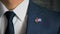 Businessman Walking Towards Camera With Country Flag Pin-Cuba