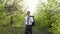 A businessman walks through the apple orchard. A man in a suit in nature.