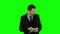 Businessman watching something in laptop and angry. Green screen