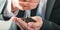 Businessman watering a sprouting seedling