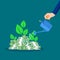 Businessman waters piles of banknotes and plants grow. profit growth concept